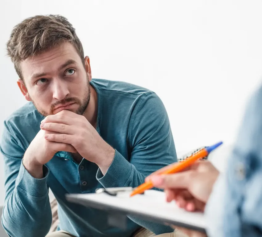 A man being helped by a therapist